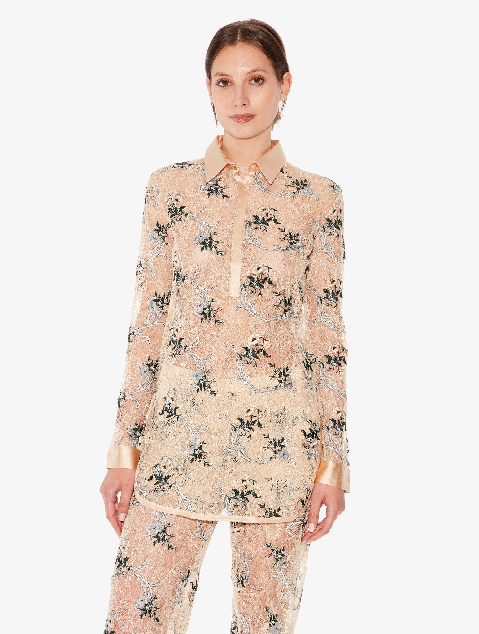 Woman wearing a floral pajama set on a white background