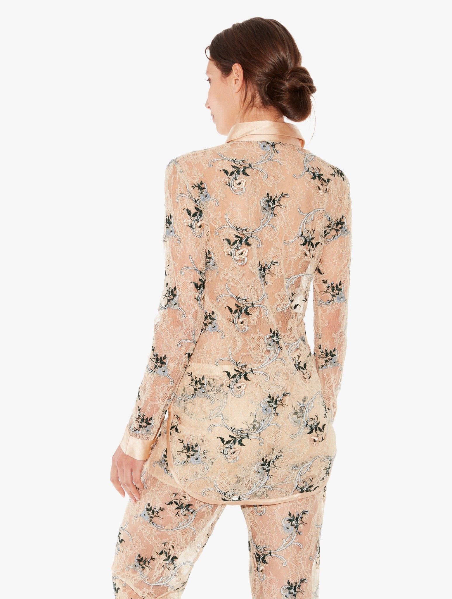 Woman wearing a floral pajama set on a white background