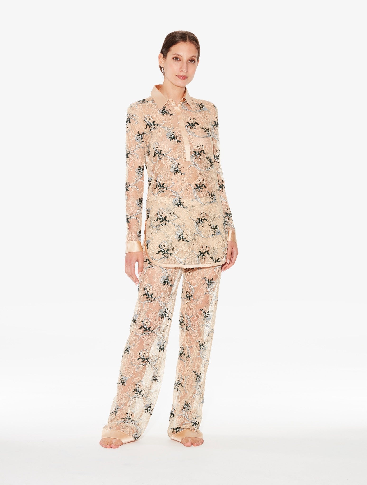 Woman wearing a floral pajama set on a white background