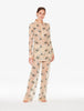 Woman wearing a floral pajama set on a white background