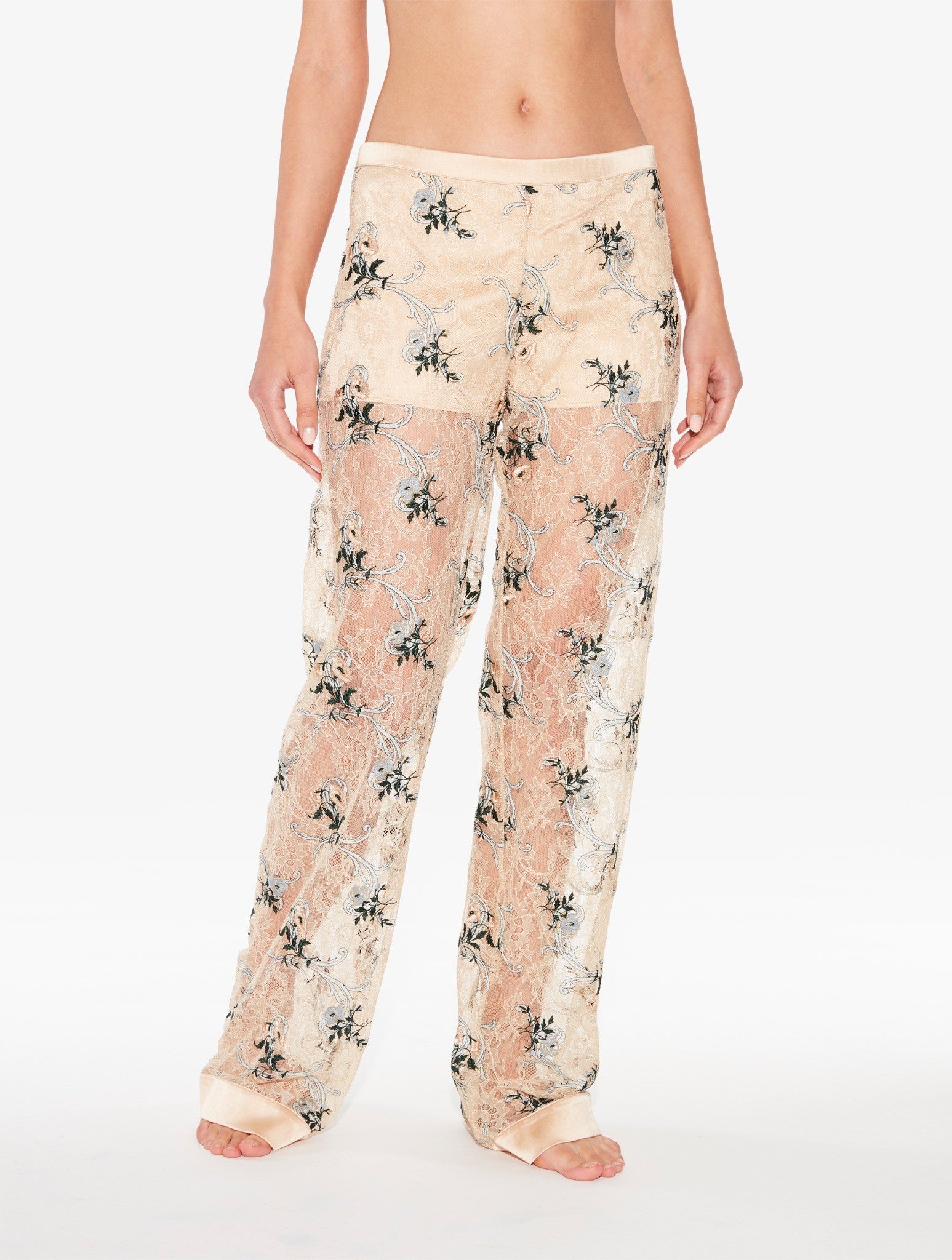 Floral-patterned pajama pants worn by a person on a white background