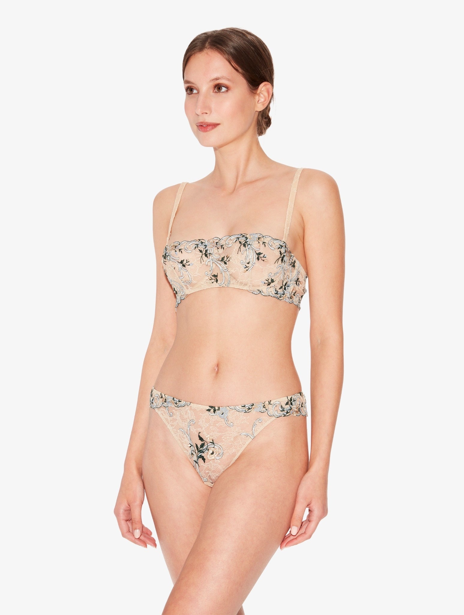 Woman wearing a floral lingerie set on a white background