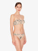 Woman wearing a floral bandeau top and underwear set on a white background